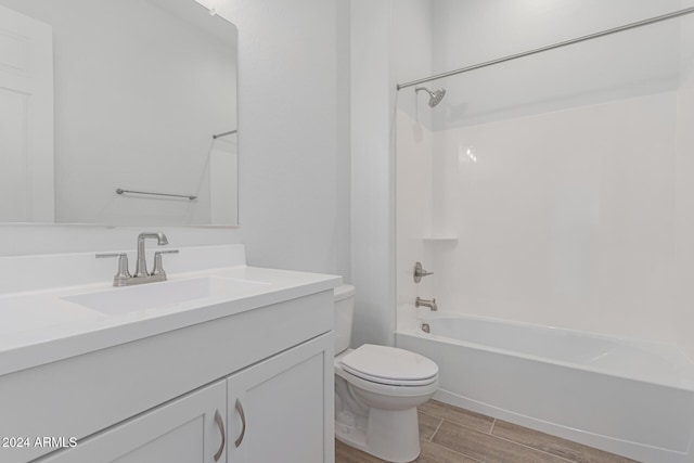 full bathroom with vanity, toilet, wood-type flooring, and tub / shower combination