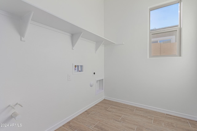 clothes washing area with hookup for a gas dryer, hookup for an electric dryer, washer hookup, and light hardwood / wood-style floors