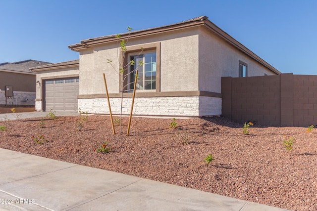 view of side of home with a garage