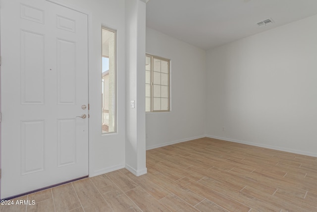 foyer with light hardwood / wood-style flooring and a wealth of natural light