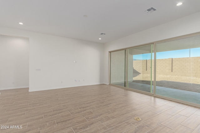 empty room with light hardwood / wood-style flooring