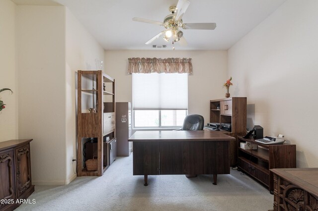 office area featuring light carpet, ceiling fan, and baseboards