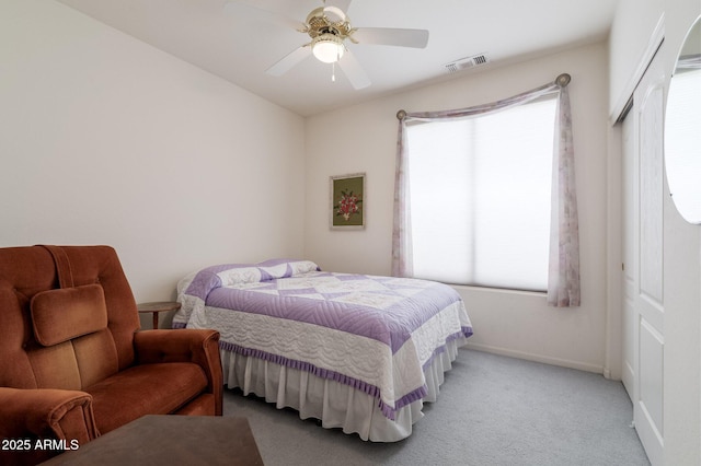 carpeted bedroom with multiple windows, a closet, baseboards, and ceiling fan