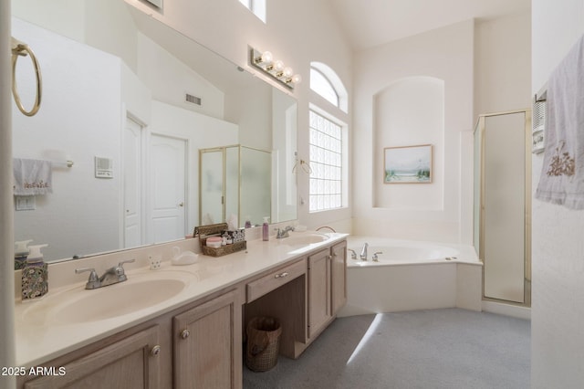 full bathroom featuring a shower stall, a garden tub, double vanity, and high vaulted ceiling