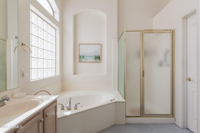 full bathroom featuring a stall shower, a bath, and vanity