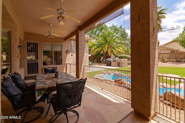 view of patio featuring ceiling fan, outdoor dining area, and fence
