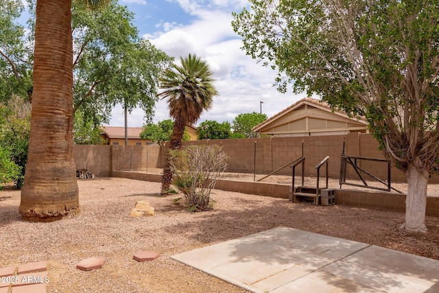 fenced backyard featuring a patio