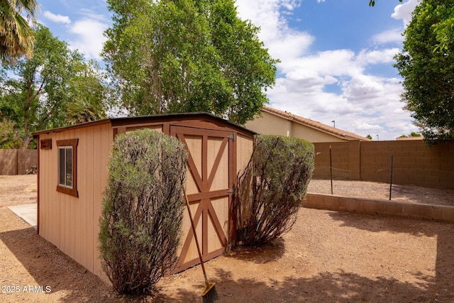 view of shed with a fenced backyard