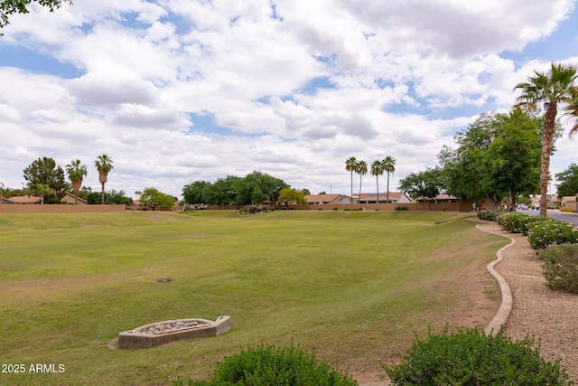view of green lawn with golf course view