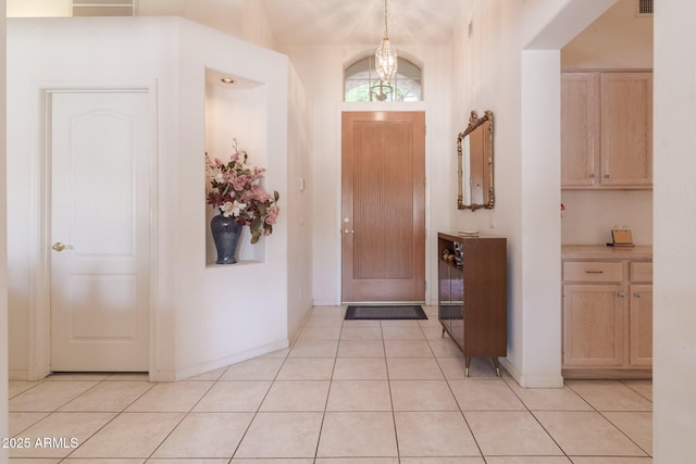 entrance foyer featuring light tile patterned flooring and baseboards