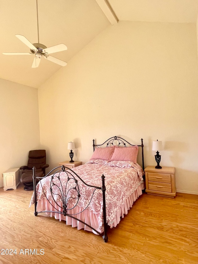 bedroom featuring lofted ceiling with beams, hardwood / wood-style floors, and ceiling fan