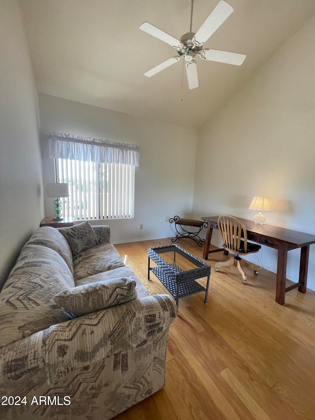 living room featuring light wood-type flooring, ceiling fan, and vaulted ceiling