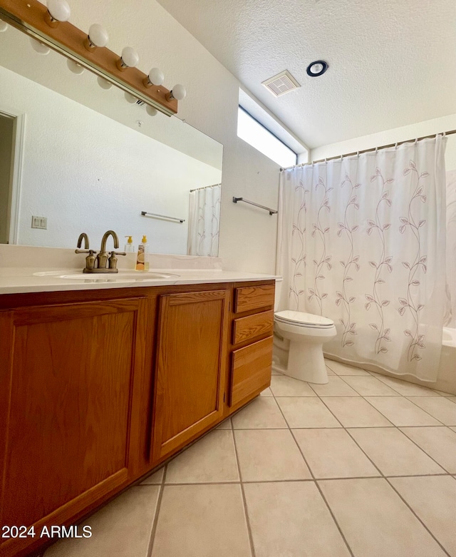 full bathroom with shower / bath combination with curtain, a textured ceiling, vanity, tile patterned floors, and toilet