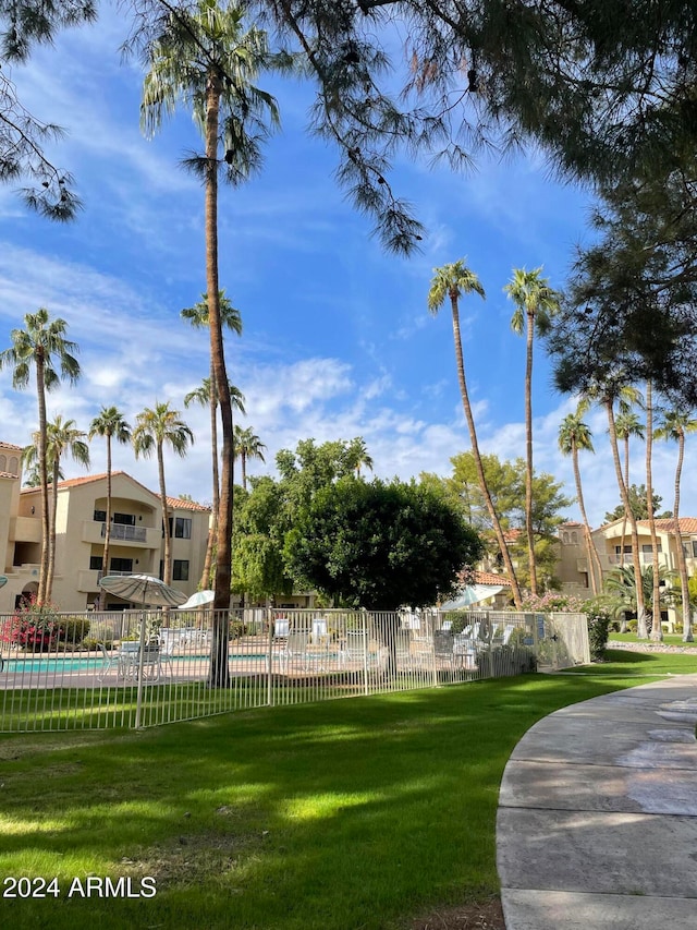 view of community with a lawn and a pool