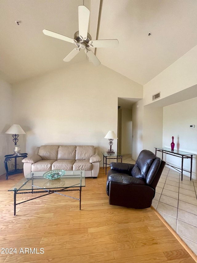 living room featuring light hardwood / wood-style flooring, ceiling fan, and vaulted ceiling