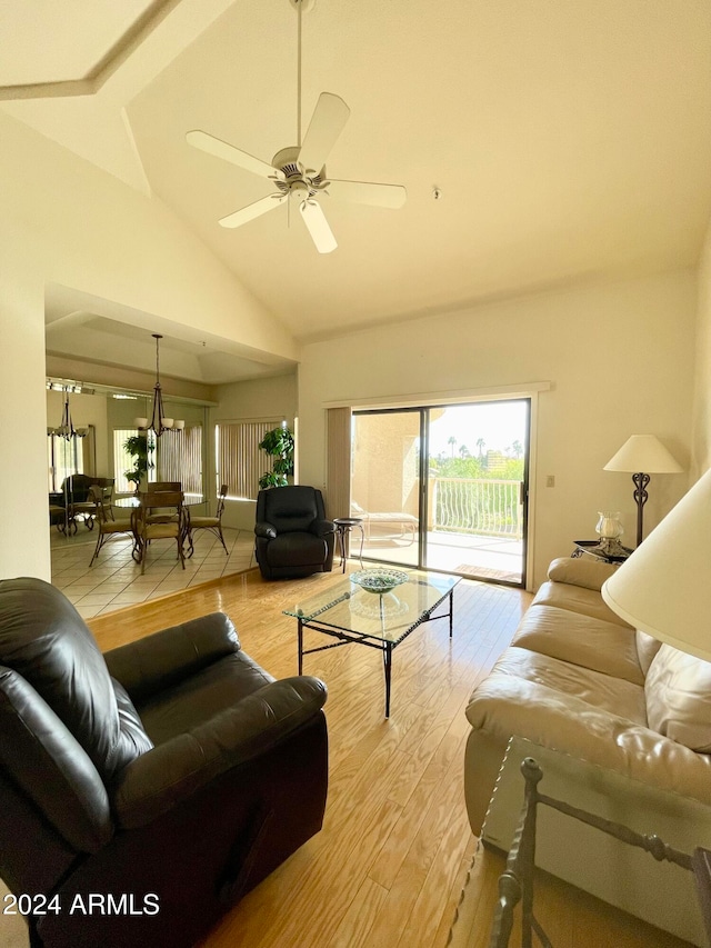 living room with high vaulted ceiling, light hardwood / wood-style floors, beamed ceiling, and ceiling fan