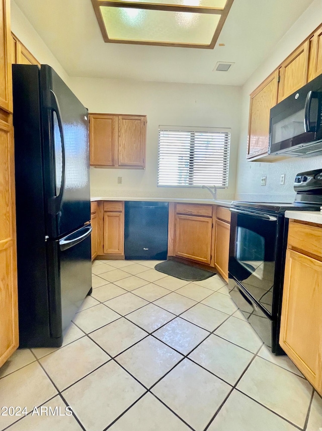 kitchen featuring black appliances and light tile patterned floors