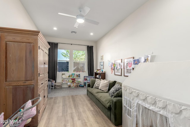 living area with recessed lighting, ceiling fan, visible vents, and light wood finished floors