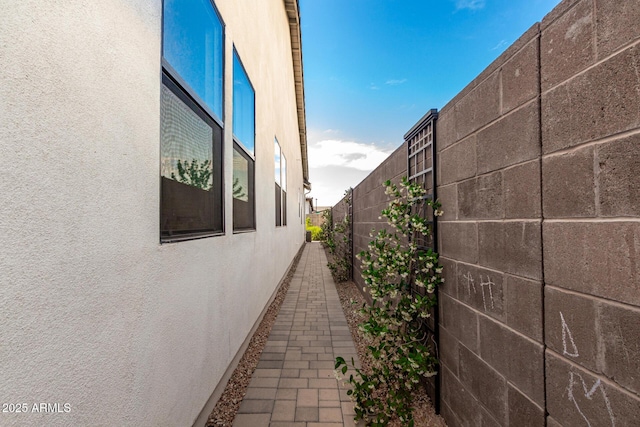 view of home's exterior featuring stucco siding and fence