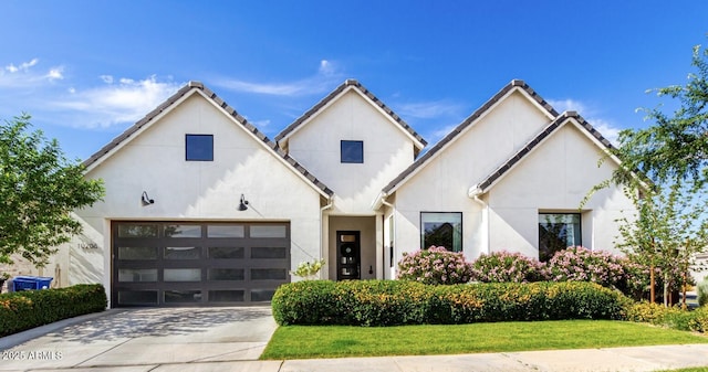 modern inspired farmhouse featuring stucco siding and concrete driveway