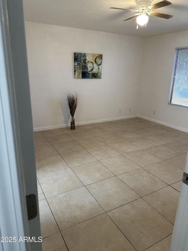 unfurnished room featuring light tile patterned floors and ceiling fan