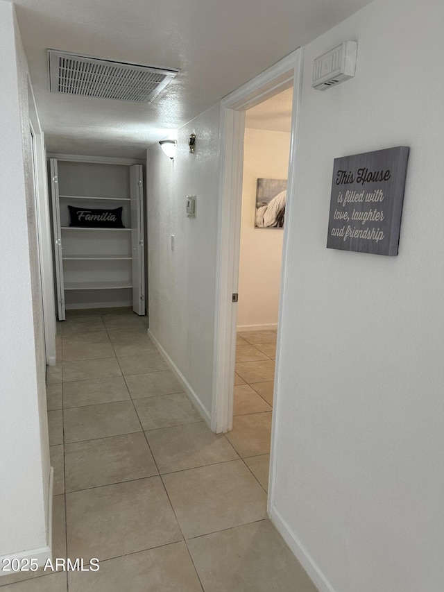 hallway featuring light tile patterned floors