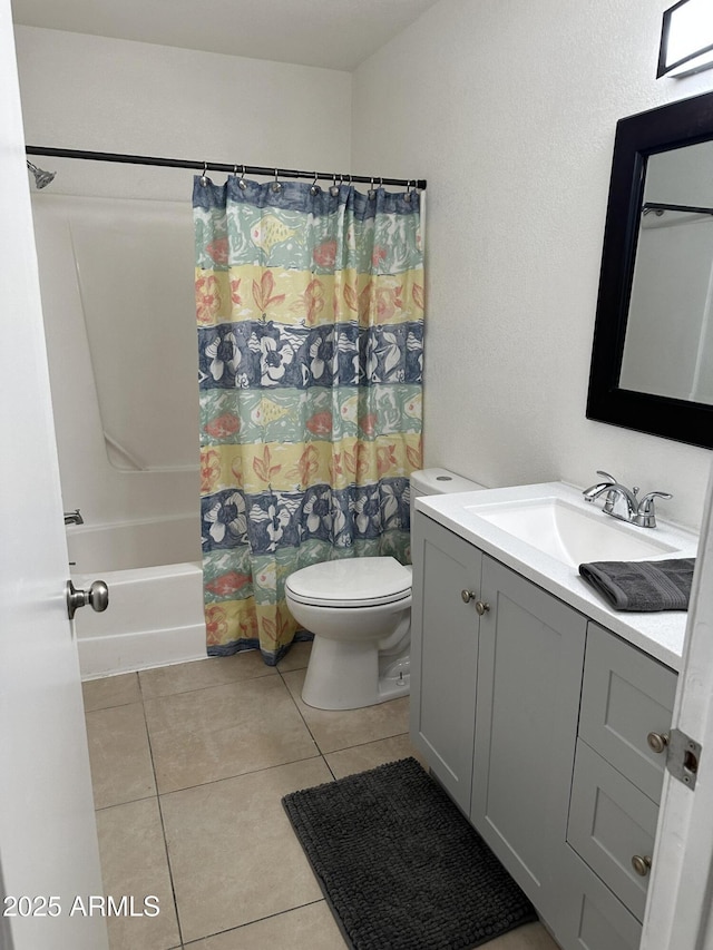 full bathroom with vanity, shower / tub combo, tile patterned floors, and toilet