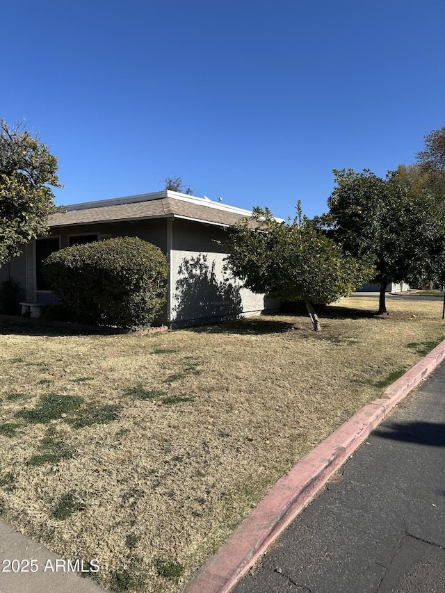 view of property exterior featuring a lawn