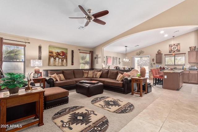 living area with vaulted ceiling, light tile patterned floors, plenty of natural light, and visible vents