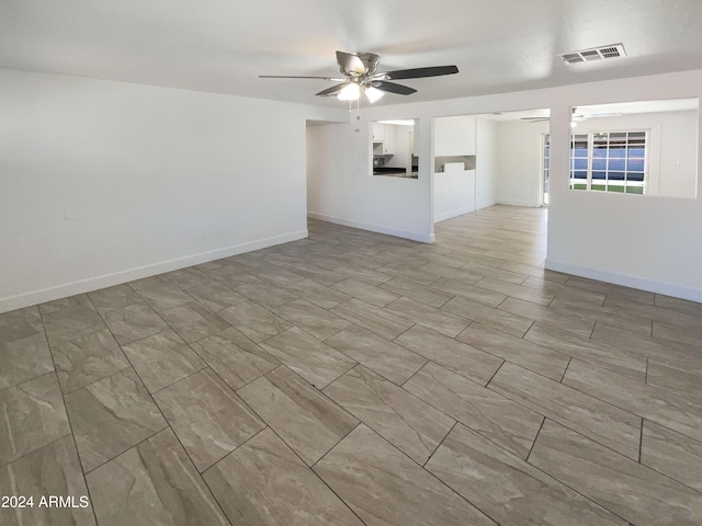 unfurnished living room with ceiling fan