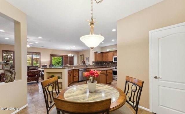 dining room with light tile patterned floors and a chandelier