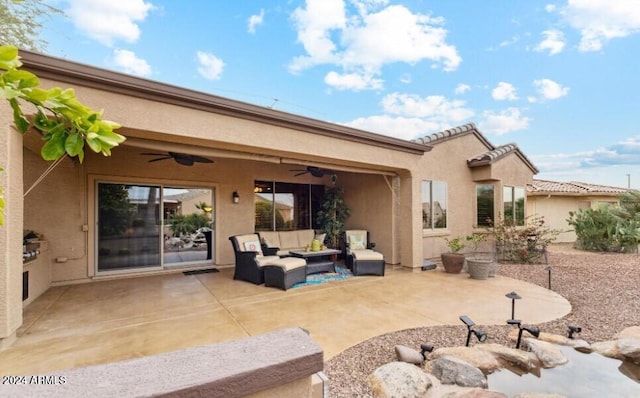 rear view of house with outdoor lounge area, ceiling fan, and a patio