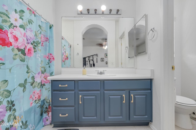 bathroom with vanity, toilet, and tile patterned flooring