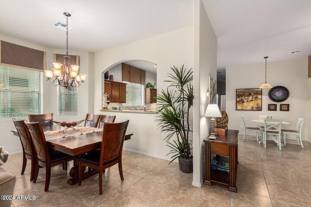 dining area with a healthy amount of sunlight, visible vents, and light tile patterned flooring