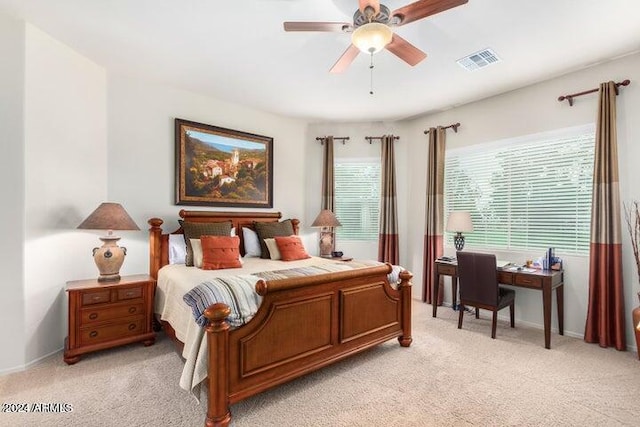 bedroom with light carpet, ceiling fan, and visible vents