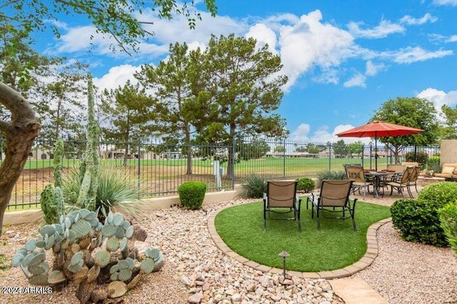 view of property's community featuring a patio area and fence