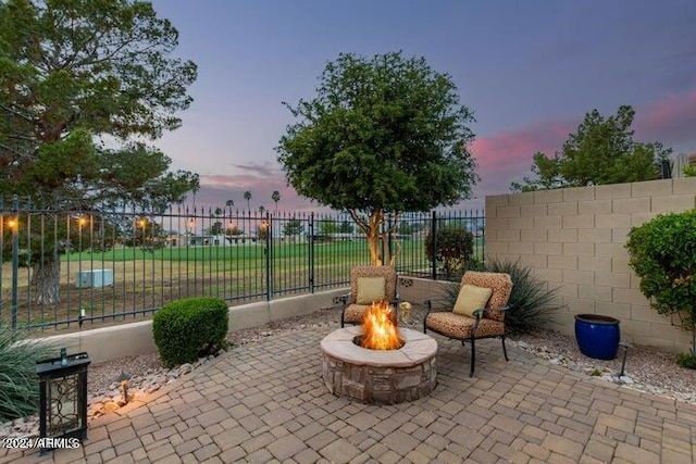 patio terrace at dusk with fence and a fire pit