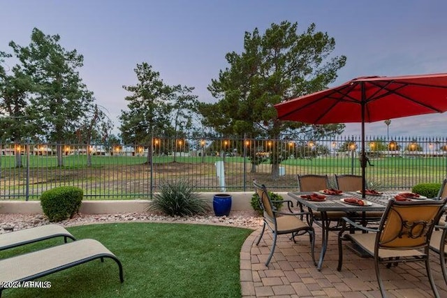 view of patio featuring outdoor dining area and fence