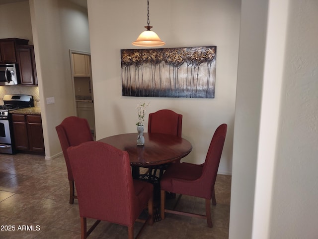 dining space featuring dark tile patterned flooring