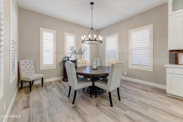 dining area featuring a chandelier and light hardwood / wood-style floors