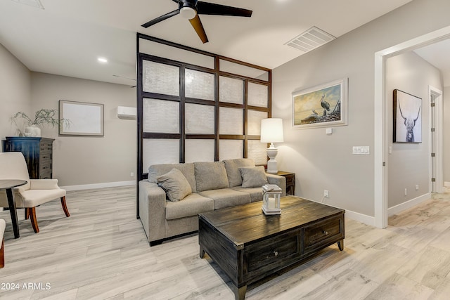 living room featuring ceiling fan and light hardwood / wood-style floors