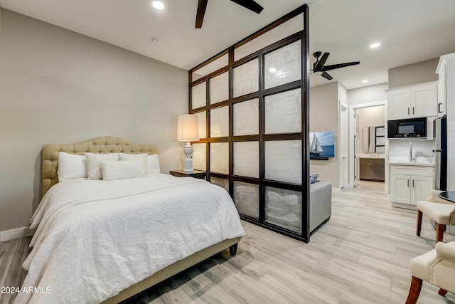 bedroom featuring stainless steel fridge, ceiling fan, light hardwood / wood-style floors, and connected bathroom