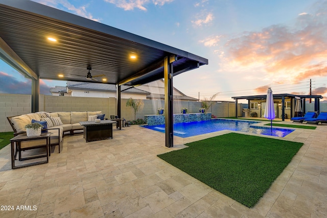 pool at dusk with outdoor lounge area, a jacuzzi, pool water feature, and a patio