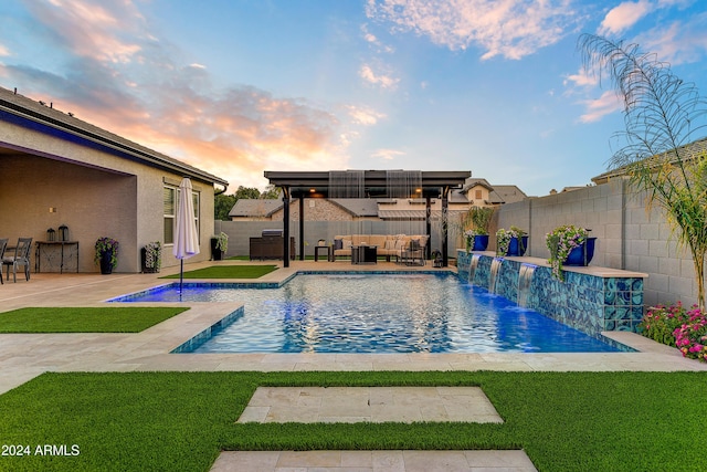 pool at dusk featuring outdoor lounge area, pool water feature, a yard, and a patio