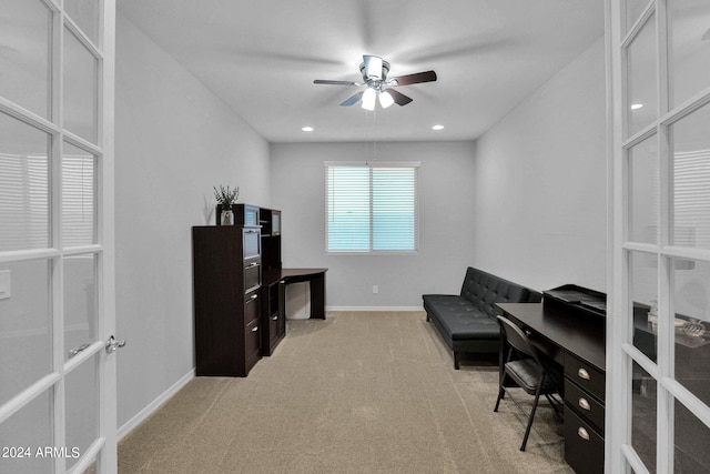 carpeted office space featuring ceiling fan