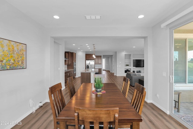 dining area featuring dark hardwood / wood-style flooring and built in features