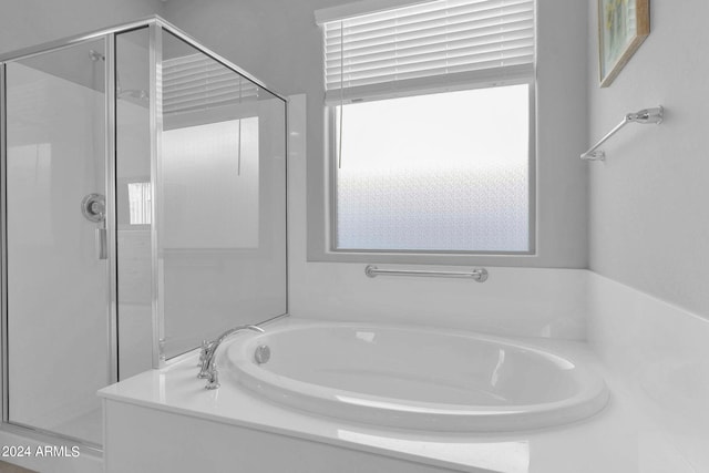 bathroom with separate shower and tub