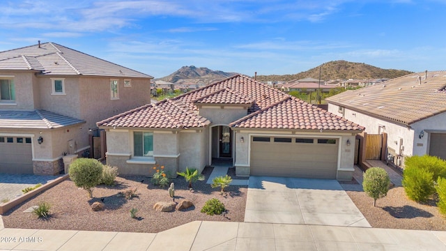 view of front of house with a mountain view and a garage