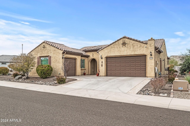 mediterranean / spanish-style house featuring a garage