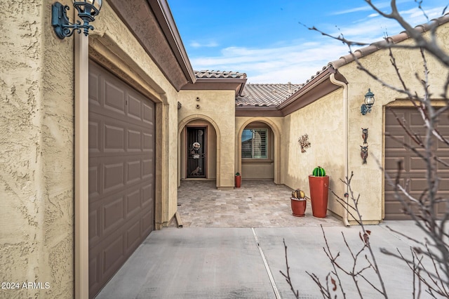 view of exterior entry featuring a garage